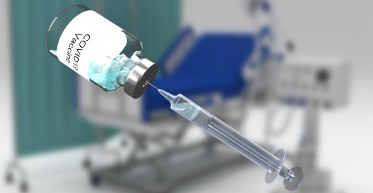 3d render medical with covid vaccine image against defocussed hospital bed