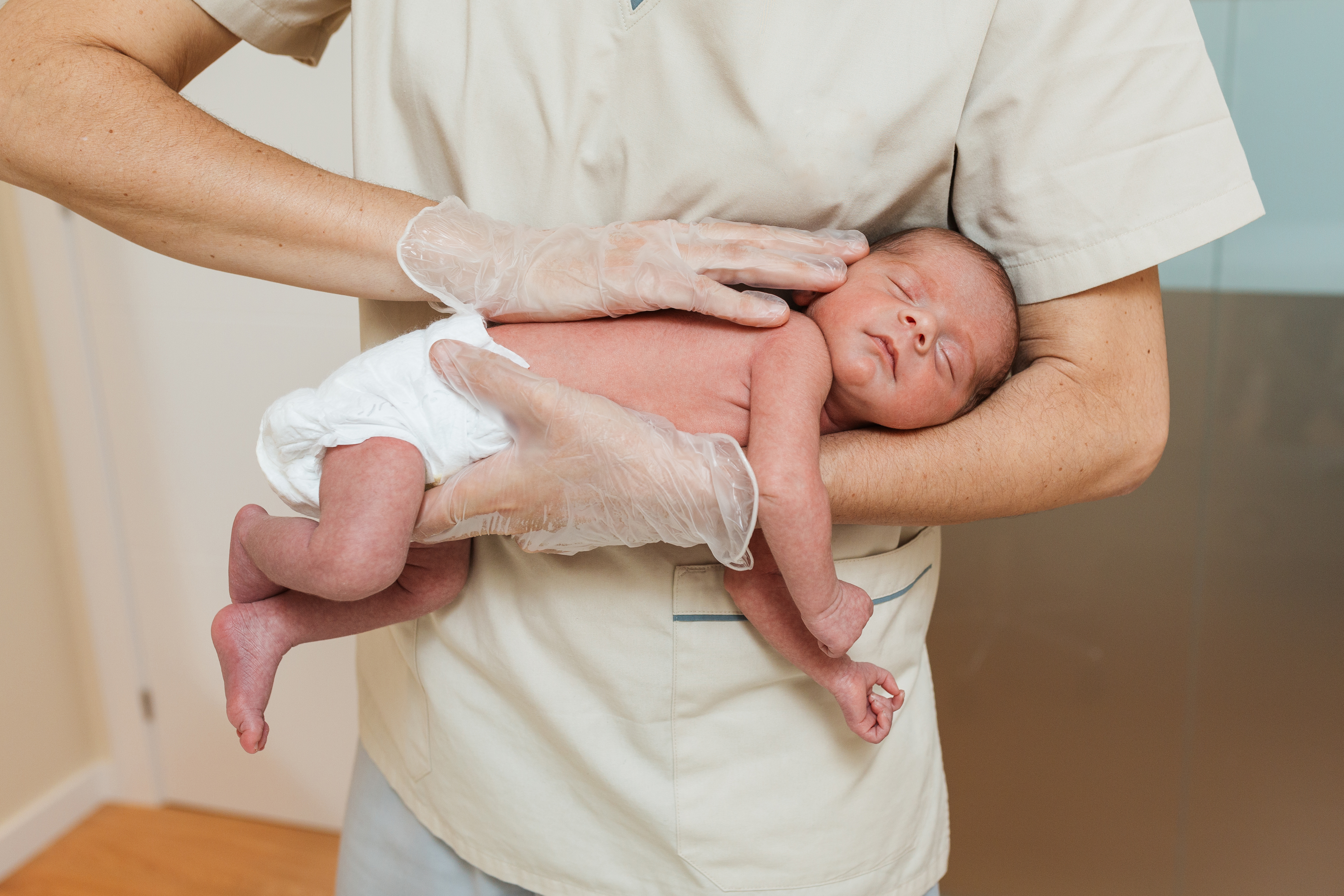 Close up view of a medical doctor examining a newborn baby. Medical and health concept.